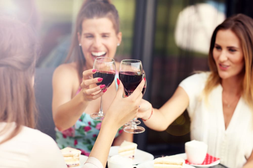 Women enjoying wine tasting at Round Lake Vineyards near our Okoboji Hotel