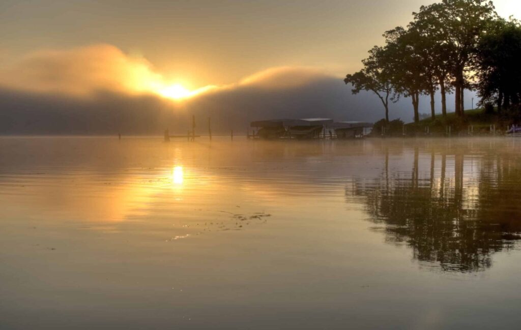 Best Iowa Getaways for Couples start with stunning sunrises over the lake